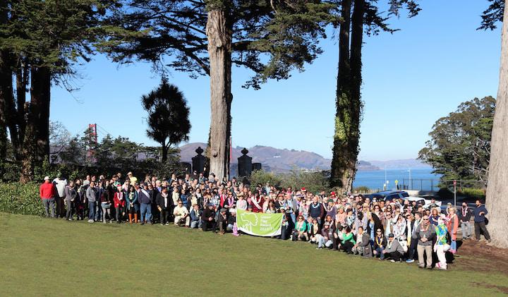 Group photo of Presidio Trust employees standing on a lawn.