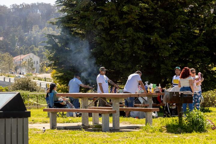 Visitors picnicking and grilling at East Beach in the Presidio.