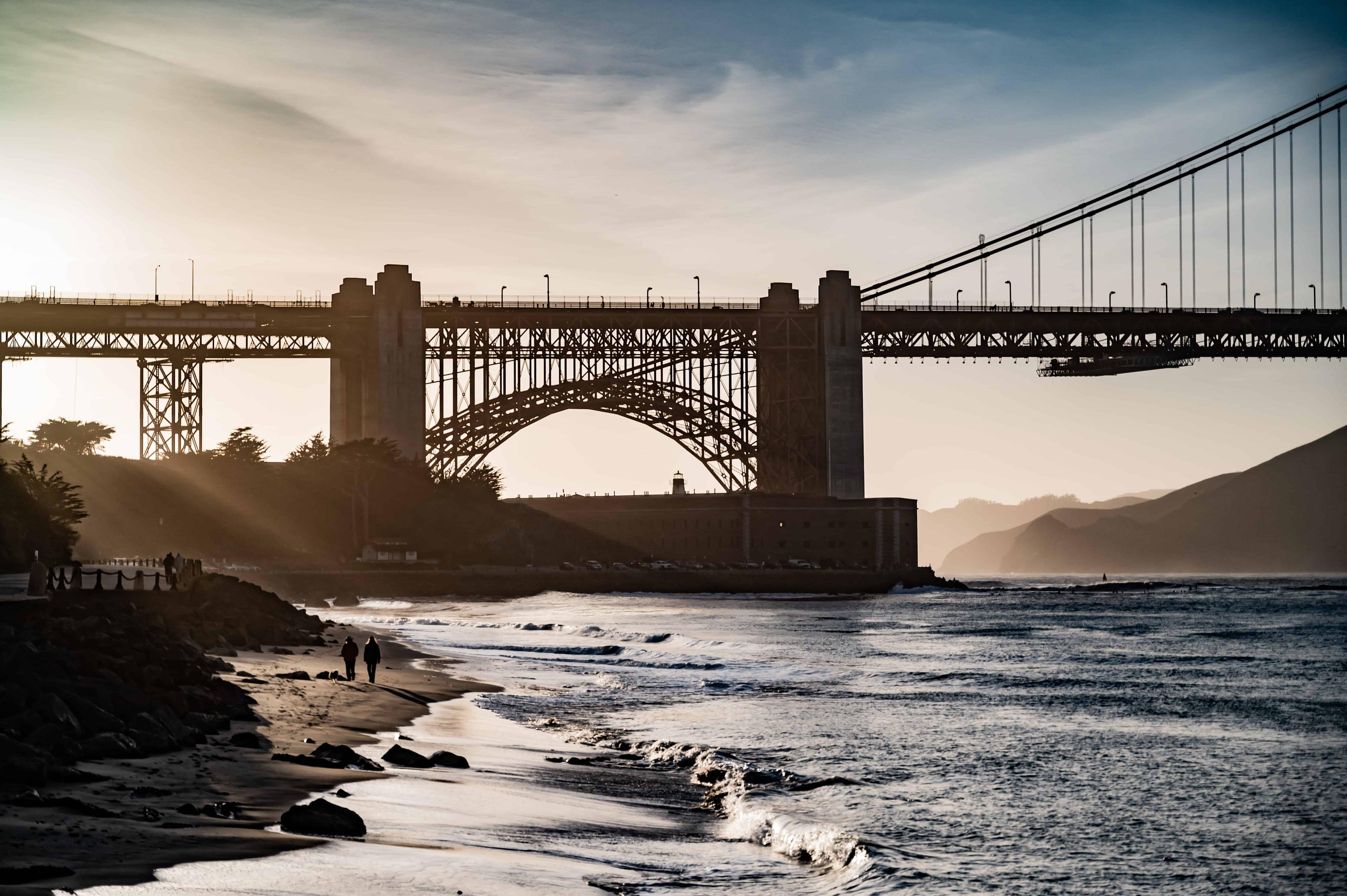 Beauty shot of Fort Point positioned in front of the Golden Gate Bridge with the sunset shining through