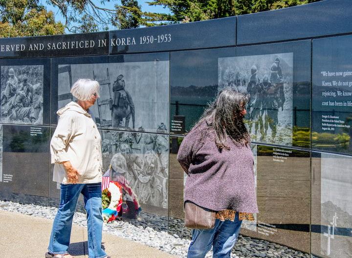 Visitors at the Korean War Memorial granite wall.