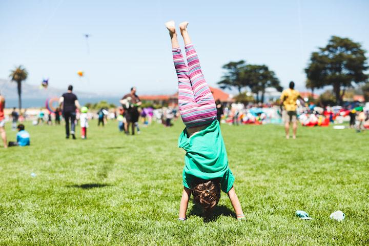 Girl doing a handstand on the Main Parade Lawn in the Presidio of San Francisco. Photo by Rachel Styer.