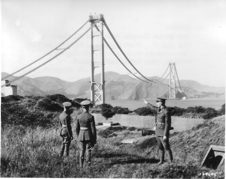 Three artillerymen watching the construction of the Golden Gate Bridge. Image courtesy NARA.